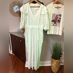 White jumpsuit with button detail on sleeve.